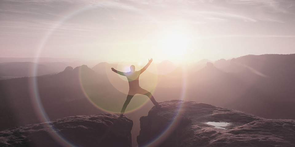 Jumping hiker celebrate triumph on cliff Jumping hiker celebrate triumph on cliff